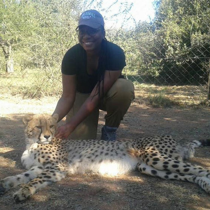 A student with a Cheeta in South Africa